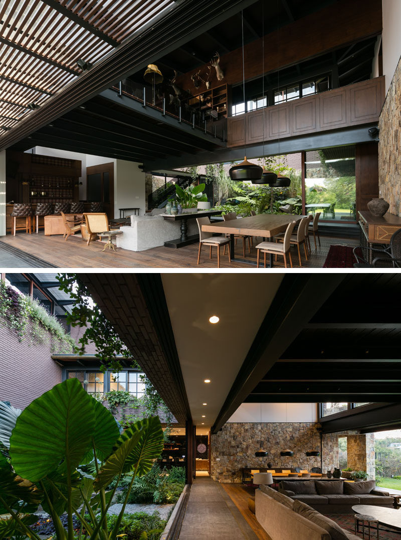 Inside this modern house, the living room, dining room and kitchen all share the same space. Both sides of the space open to green spaces, and a high ceiling allows plenty of light in.