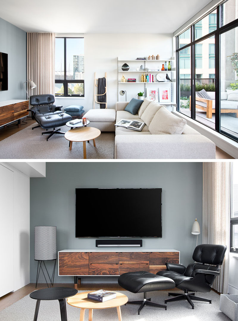 Inspired by Brooklyn's warehouse lofts, the interior of this loft apartment has modern design elements that have been combined with wood to create a bright and welcoming space. In the living room, open shelving is attached to the wall beside the couch, which is focused on the television (as the the owners are huge sports fans).