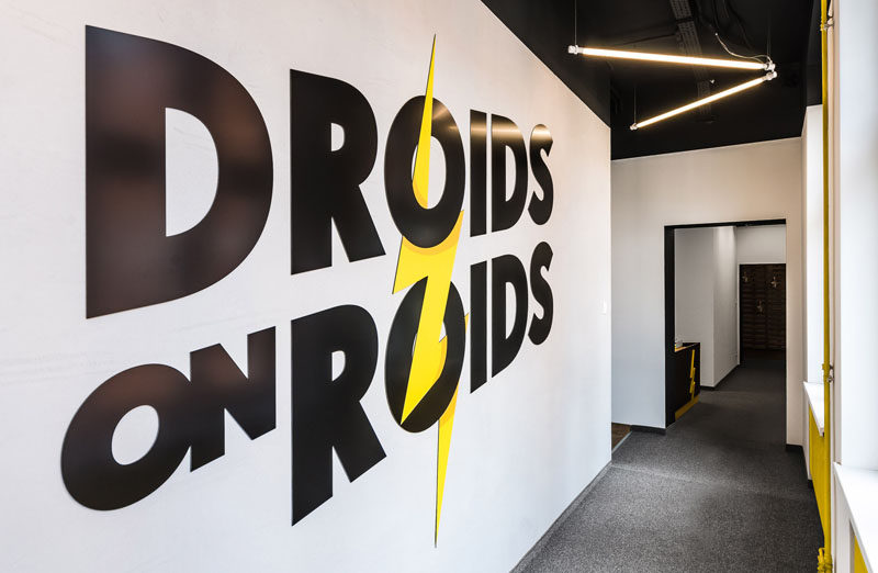 mode:lina architekci have recently completed a new office in Wroclaw, Poland, for Droids On Roids, a tech company. The design of the office takes inspiration from their logo, and throughout the space there's references to the color and the lightning bolt.