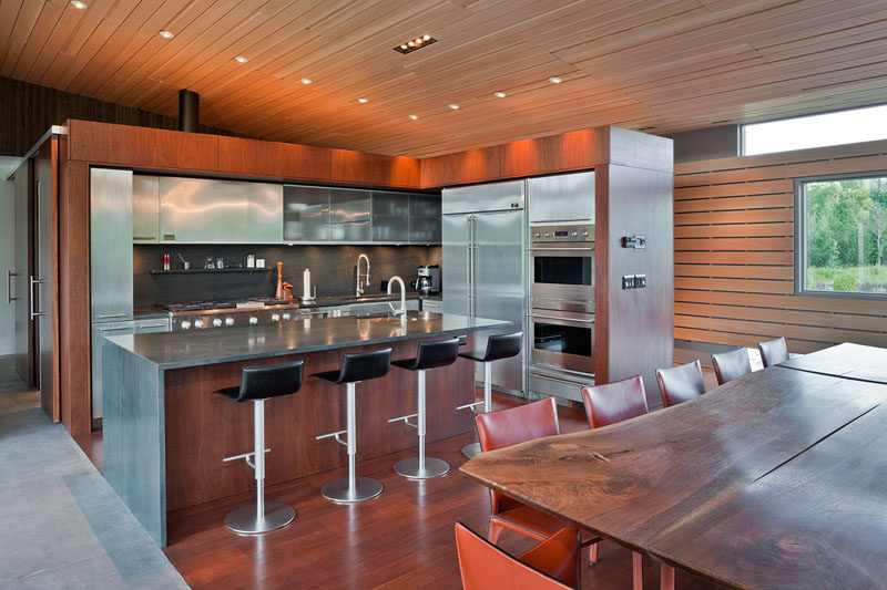 Stainless steel cabinets have been combined with wood to give this kitchen an industrial yet contemporary appearance.