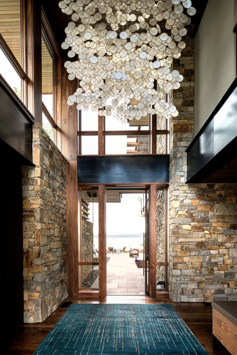 Stepping inside into this contemporary entryway, you can see straight through to the lake.