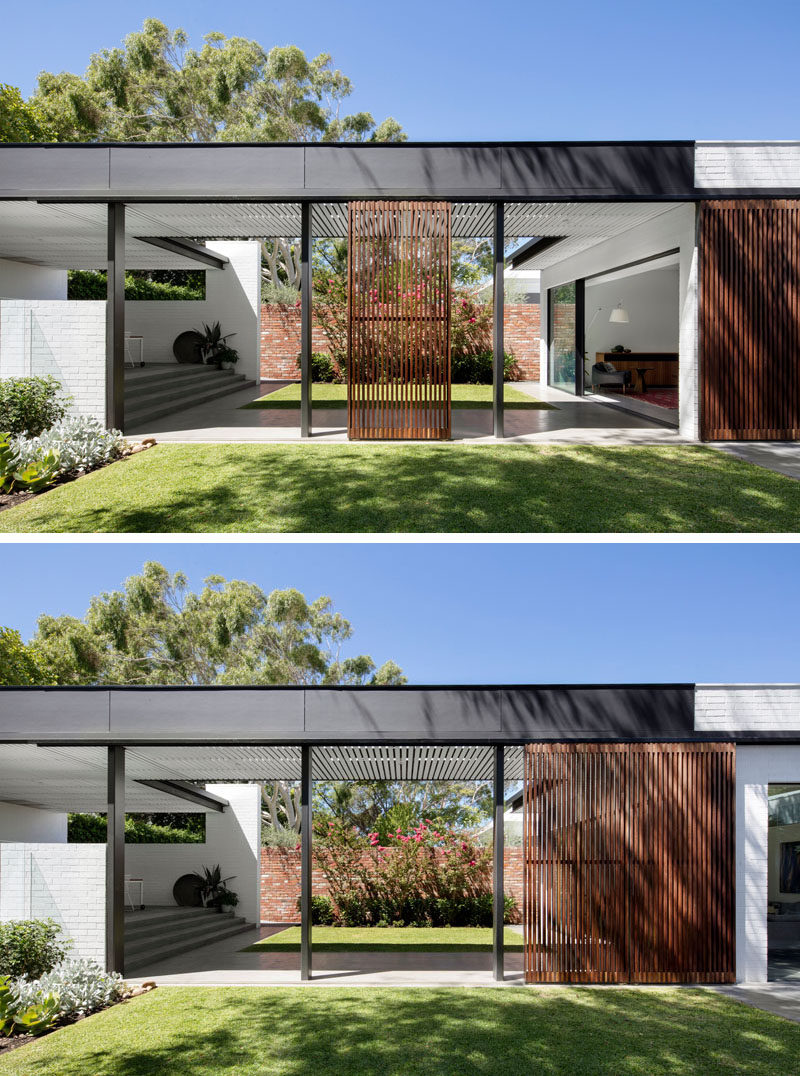 A covered walkway connects this house to the various areas of the new backyard, while operable timber screens have been included to provide shade when needed.