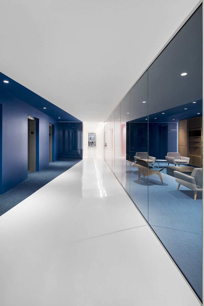 This contemporary and open-concept office design is mostly white, however bold pops of color have been used to define various areas throughout the interior. #Workplace #OfficeDesign #InteriorDesign #Office #Colors