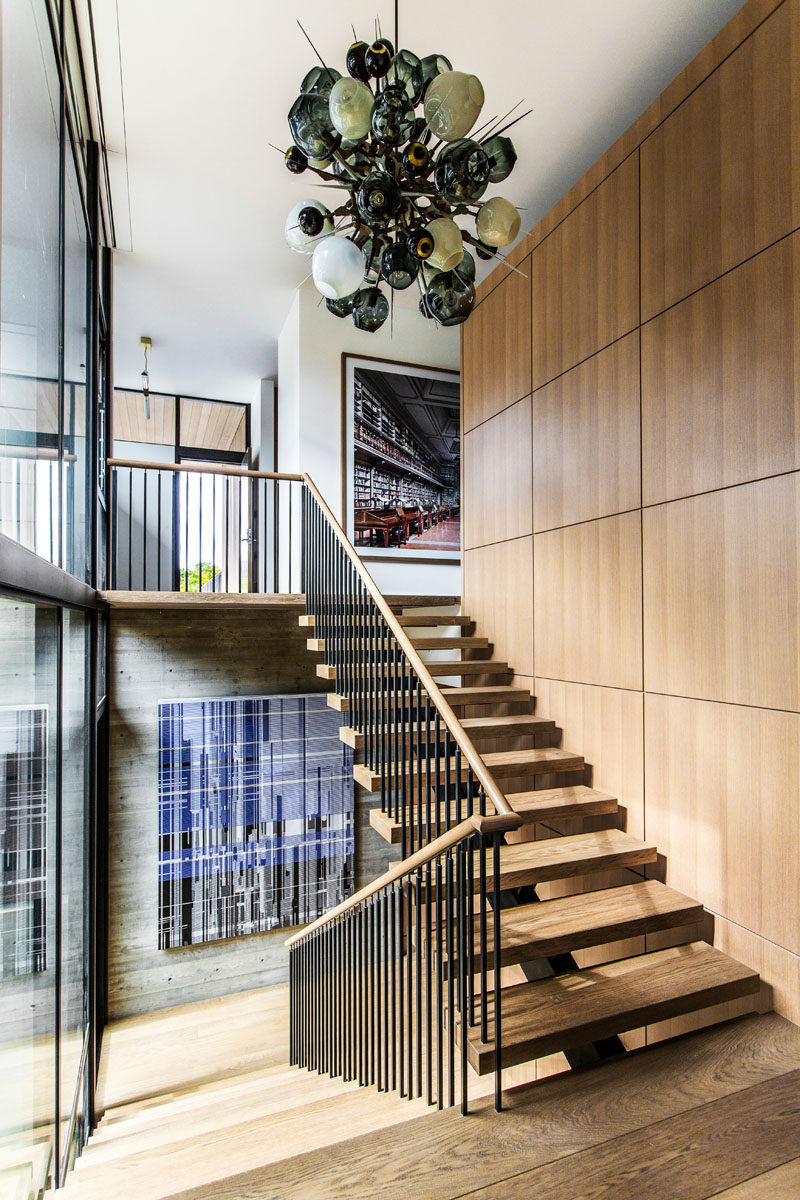 Wood and steel stairs lead up to the upper floor of this modern house. #Stairs #ModernStairs #Staircase