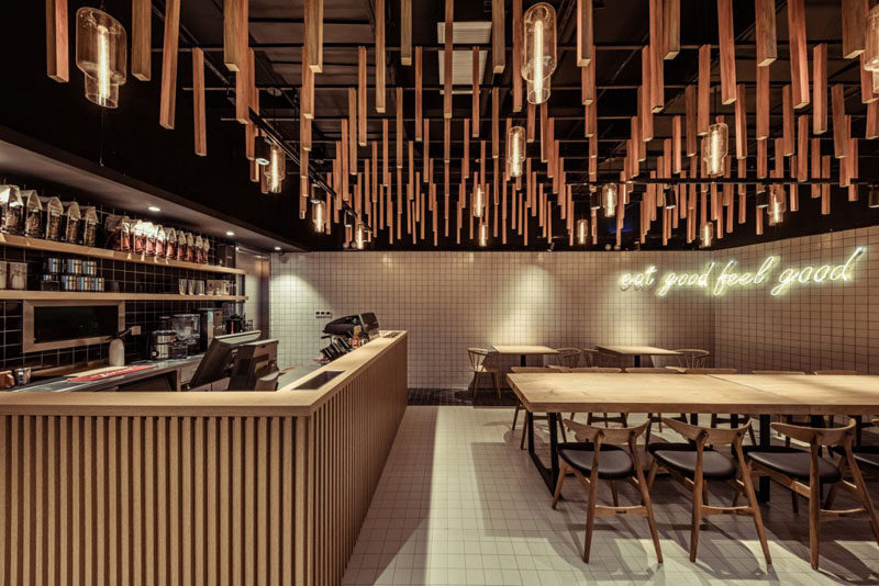 For the interior of this modern coffee shop, the designers took their inspiration from nature. The wanted to create a calm and relaxing place for the customers where they could gather and feel like they are relaxing under the trees, emulating the comforts and tranquility of an open forest canopy.