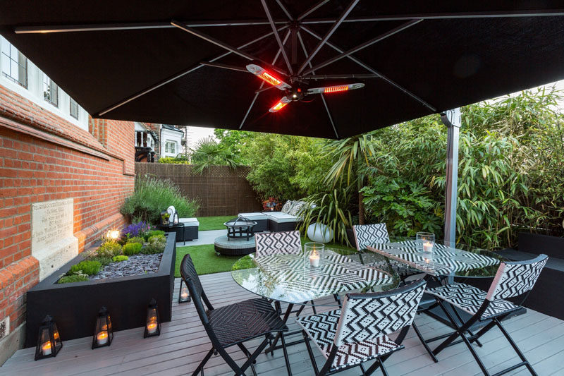 This modern landscaped outdoor space features a dining patio and outdoor lounge. #landscaping #SmallBackyard #OutdoorSpace