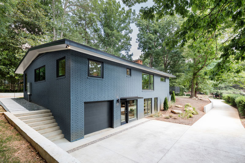 This mid-century modern brick house was updated with a bold blue painted brick exterior.