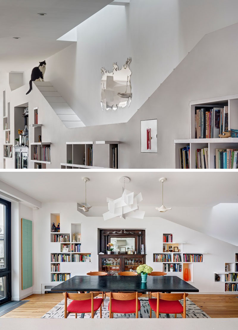 This renovated row house in Brooklyn has a custom built-in bookcase that runs the entire length of the home and it was specifically designed to allow the home owner's cats to climb it and have space to explore. #Cats #InteriorDesign #Shelving #Bookshelf #Bookcase