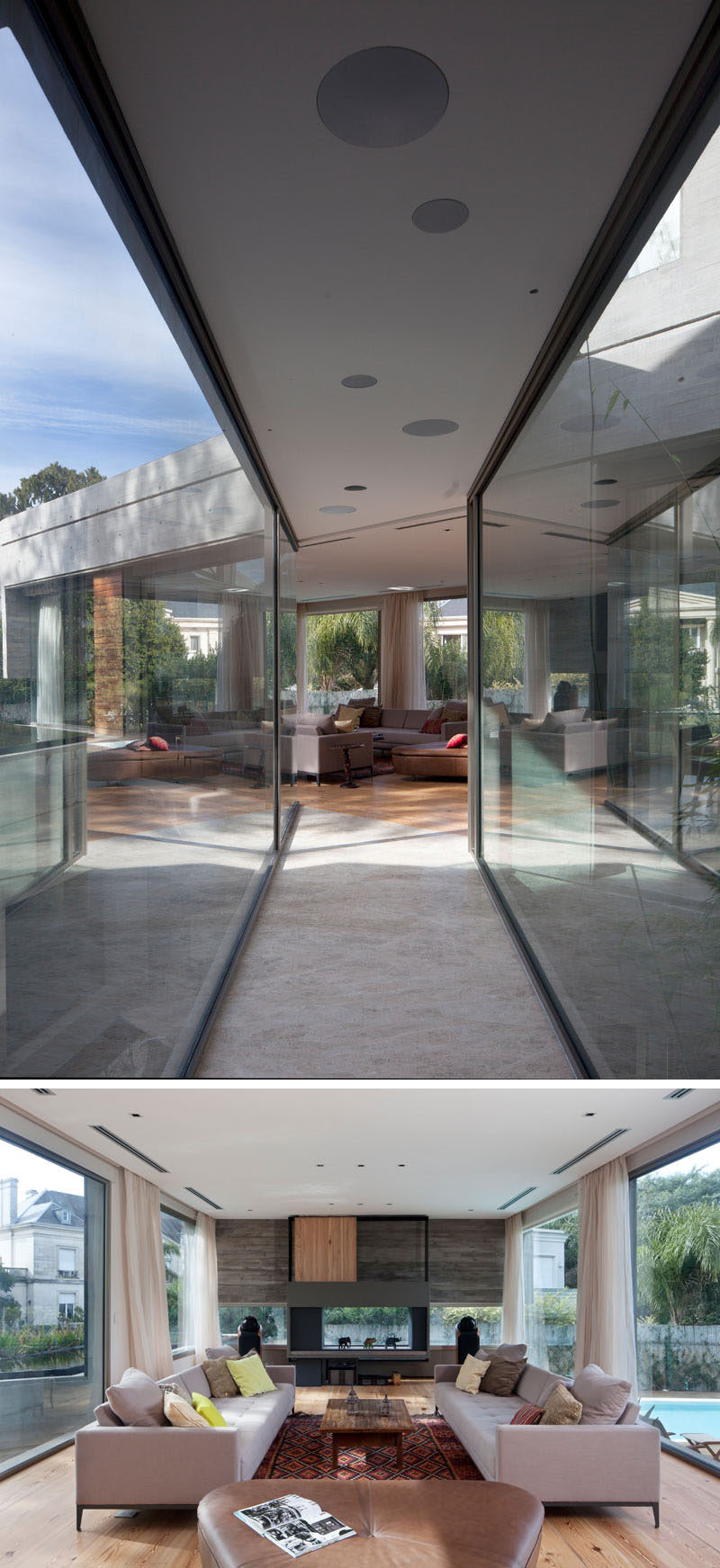 A bridge with large windows on either side connect the various areas of this modern house like the living room, that also has floor-to-ceiling windows looking out over the backyard on one side and the pond on the other. #Architecture #ModernHouse #ConcreteHouse #LivingRoom