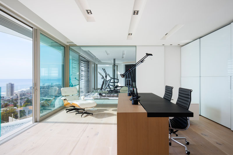 This modern house has a home office with views of the skyline and gym next door. #ModernHomeOffice #Study