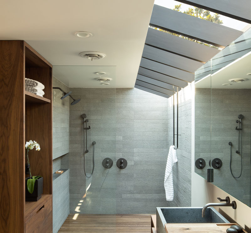 In this modern bathroom, a large skylight keeps the space feeling bright and open, while a glass shower screen separates the two person shower from the rest of the bathroom. #ModernBathroom #Skylight #ShowerForTwo #BathroomDesign