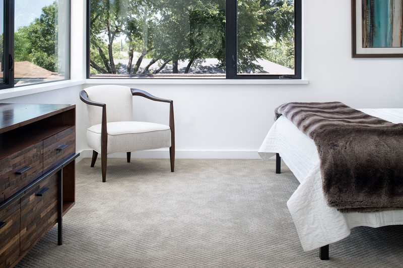 This master bedroom has black-framed windows that provide views of the backyard and fill the room with natural light. #Bedroom #Windows