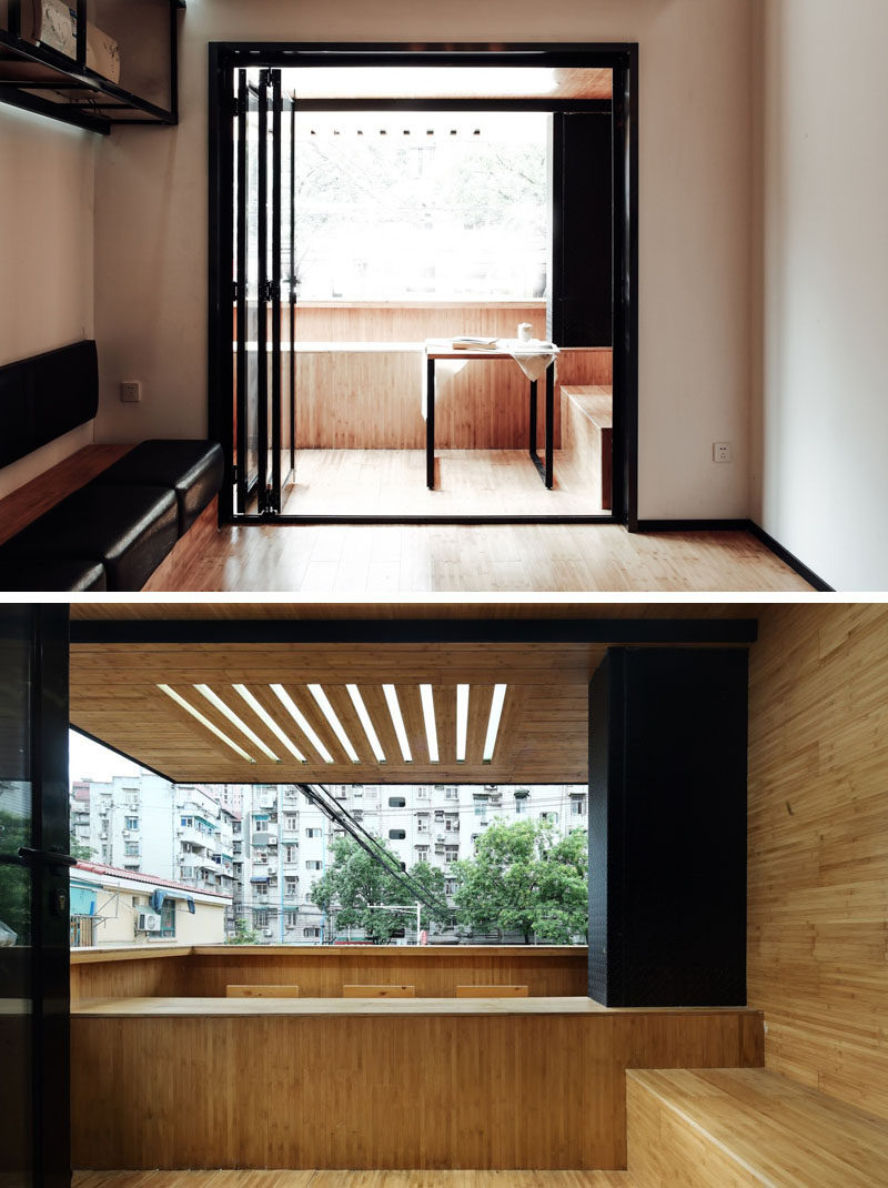 Folding black-framed glass doors open up to a small outdoor area with a built-in bench that backs on to the porch at the front of this modern cafe. #Cafe #CoffeeShop #InteriorDesign