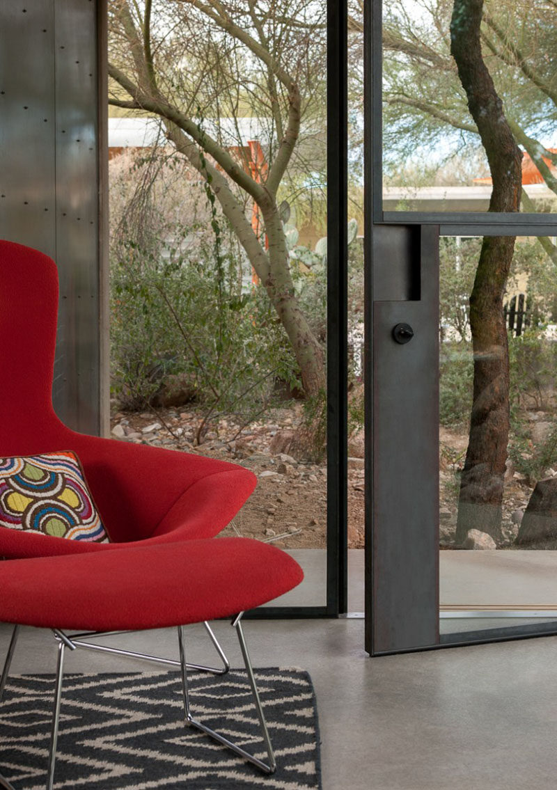 Industrial touches like concrete walls and flooring, and steel frames for the windows and doors have been included in the design of this modern guest house. #Industrial #Architecture #InteriorDesign #Door