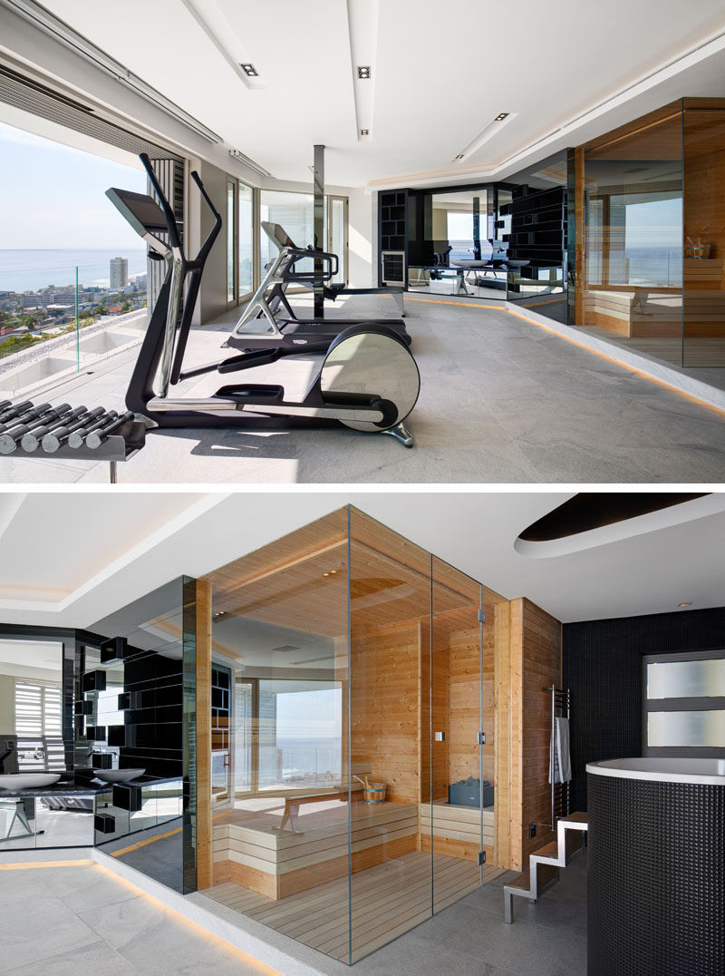 In this modern home gym, there's a spa bathroom with a sauna and chiller bath. Mirrors above a vanity reflect the view outside. #ModernHomeGym #Sauna #ModernGym