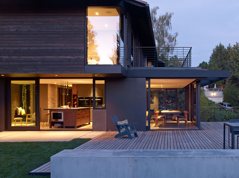 This modern renovated house has an outdoor entertaining area and a grassy yard, that can be accessed from both the kitchen and dining room. #OutdoorSpace #Backyard #Deck #Landscaping #ModernHouse