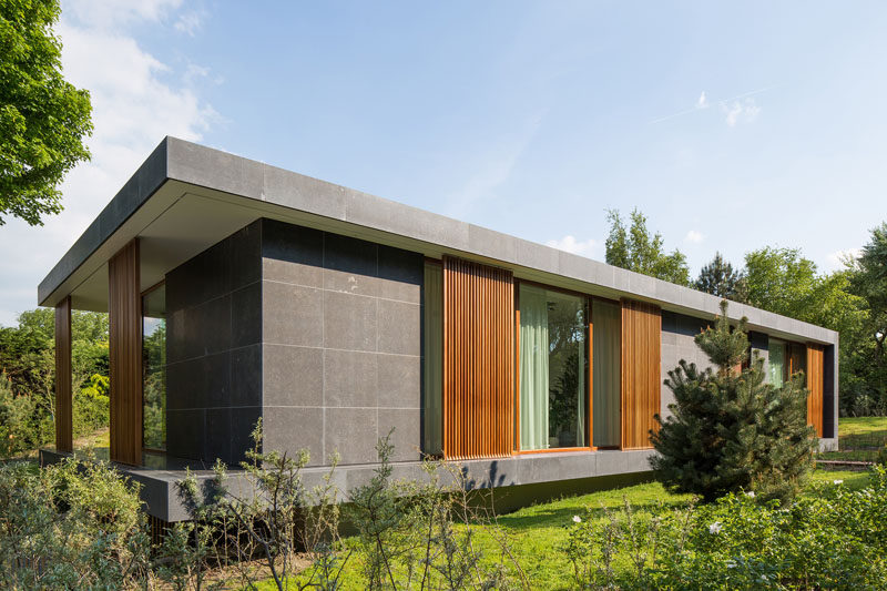 Architecture firm BERG + KLEIN, have designed a new villa in Hoek van Holland, The Netherlands, that combines concrete, wood and natural stone to create a modern facade. #ModernHouse #Stone #Wood #Architecture