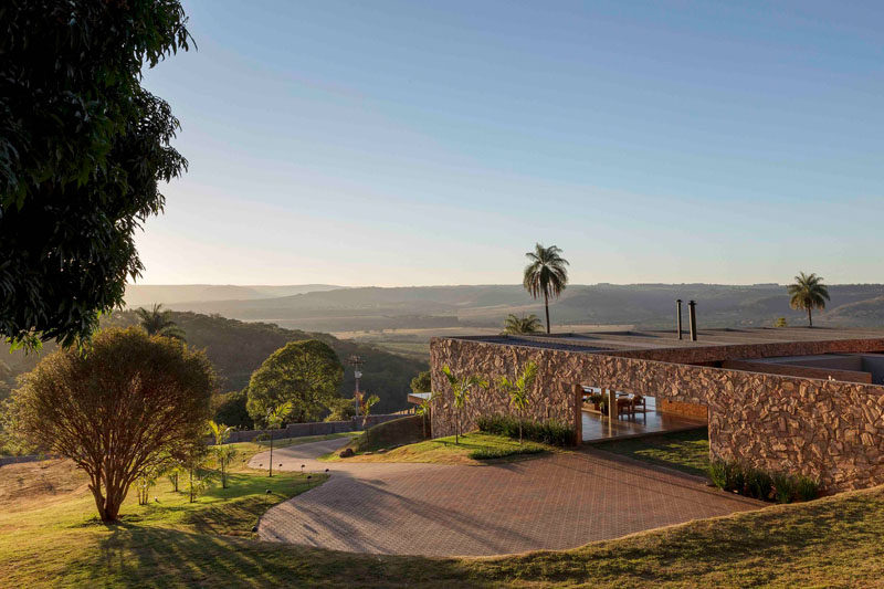 This stone, brick and wood modern house has a curved driveway. #Driveway #ModernHouse #StoneHouse