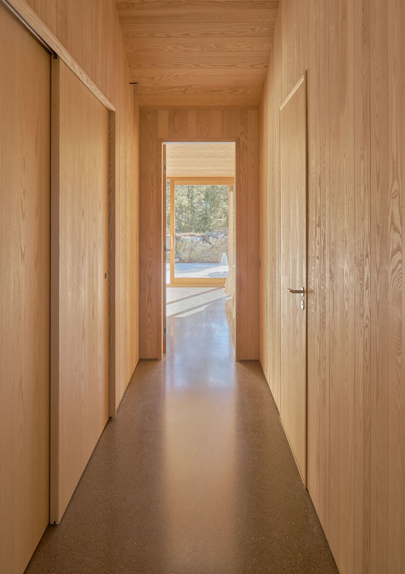 In this Scandinavian holiday house, the doors blend in to their wooden surrounds. #Scandinavian #InteriorDesign #Hallway