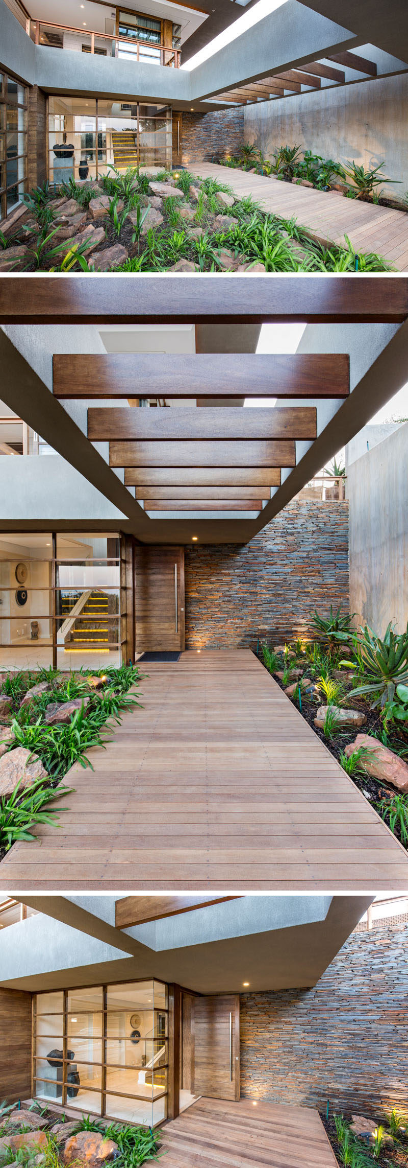 At the front of this modern house and off to the side, there's a wood walkway surrounded by plants and rocks, that leads to the front door. #Landscaping #Architecture #FrontEntrance #ModernHouse #WoodPath