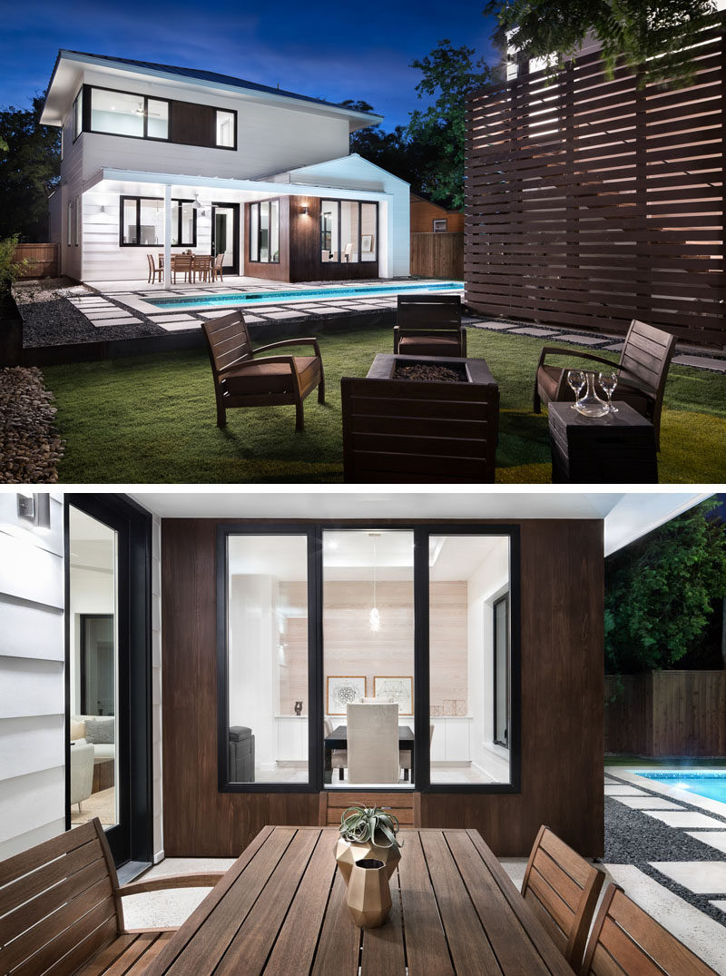 The backyard of this modern house has a covered outdoor dining area just off the living room, lap pool and a fire pit with seating, all perfect for entertaining guests. #Landscaping #Backyard #LapPool #OutdoorDining #Firepit