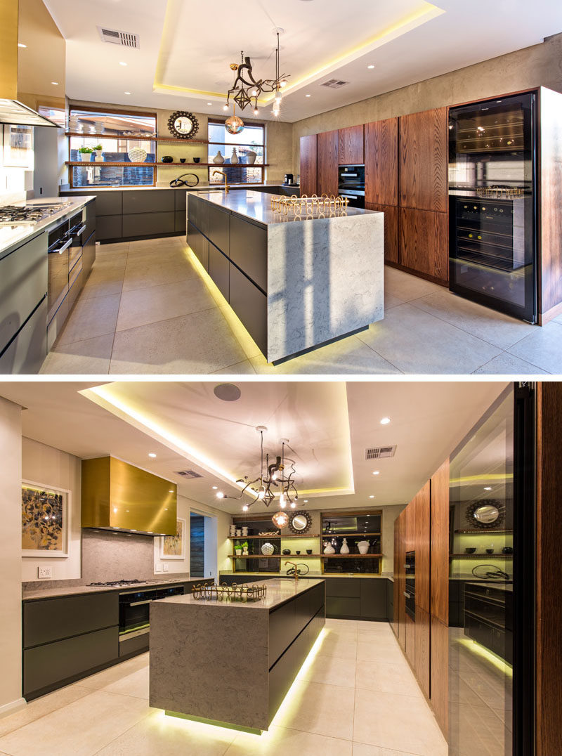 In this modern kitchen there's hidden lighting in the recessed ceiling as well as under the the kitchen island. #HiddenLighting #ModernKitchen #KitchenDesign