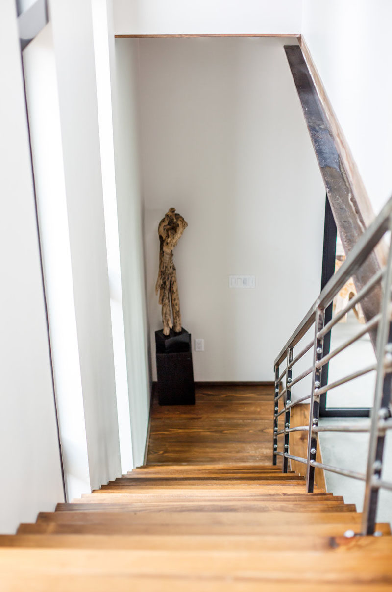 These warm, rich wood stairs are highlighted by the use of simple white walls. #InteriorDesign #Stairs #WoodStairs