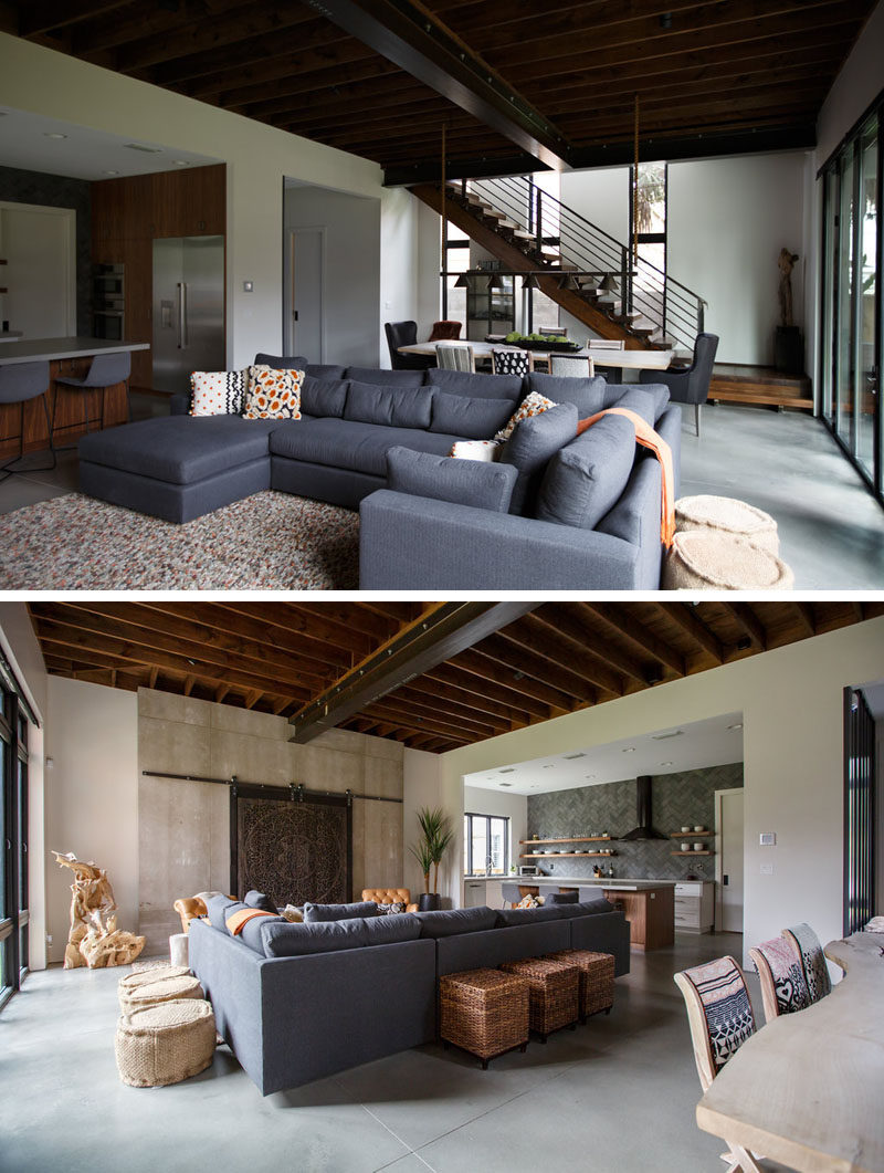 This modern house interior features exposed wood and steel beams that draw the eye upwards to make the room feel large and spacious. #InteriorDesign #ExposedCeiling #ModernInteriorDesign