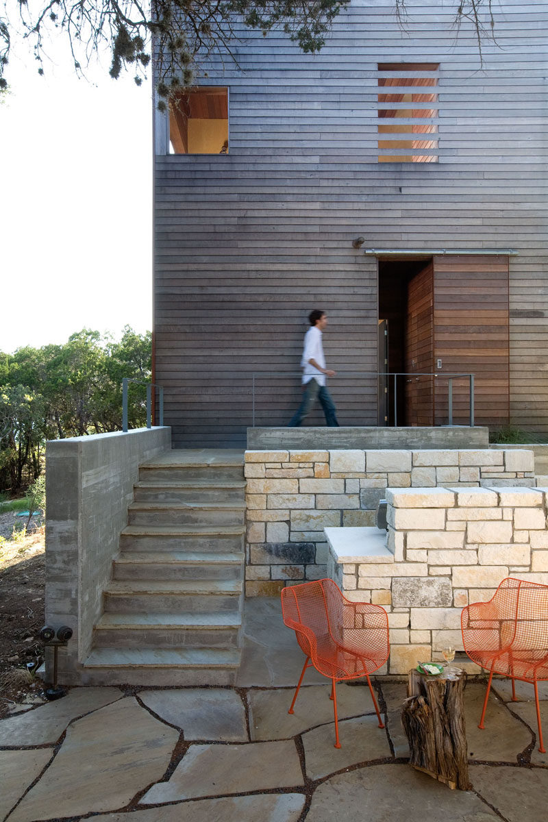 A flagstone path with concrete stairs lead up to the entrance of this tower, while the exterior of the tower is clad in Massaranduba wood. #Flagstone #ConcreteStairs #WoodFacade #ModernArchitecture