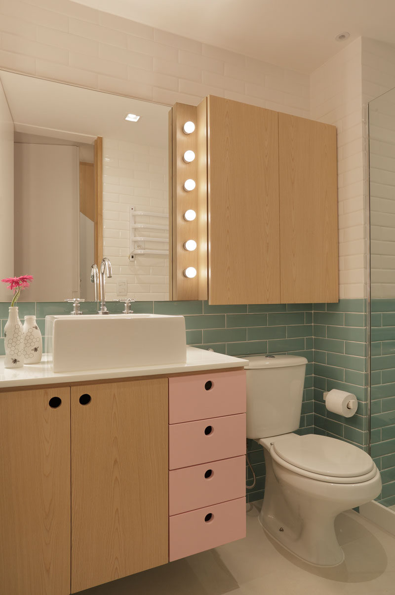 This modern bathroom uses soft colors combined with light wood and white walls. #ModernBathroom #BathroomDesign