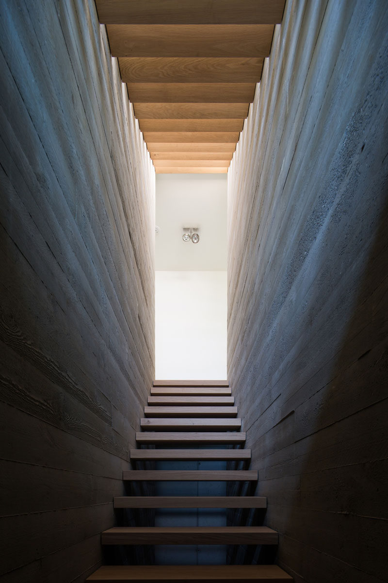 This wood staircase is positioned between two board-formed concrete walls. #ConcreteWalls #WoodStairs