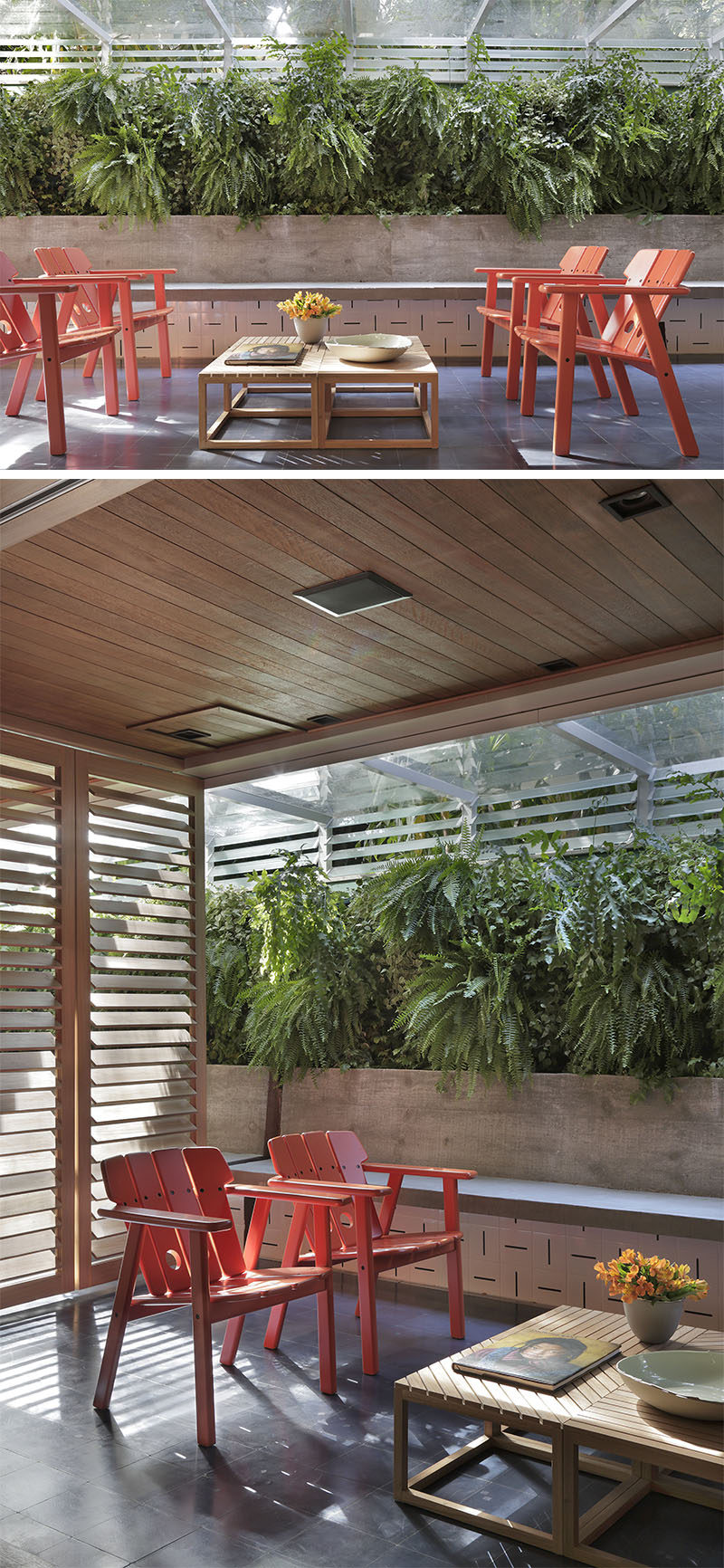 This modern apartment has a covered outdoor space with a few red chairs that add a pop of color, while large green ferns a planted behind a built-in bench. #OutdoorSpace #Apartment #LandscapeDesign