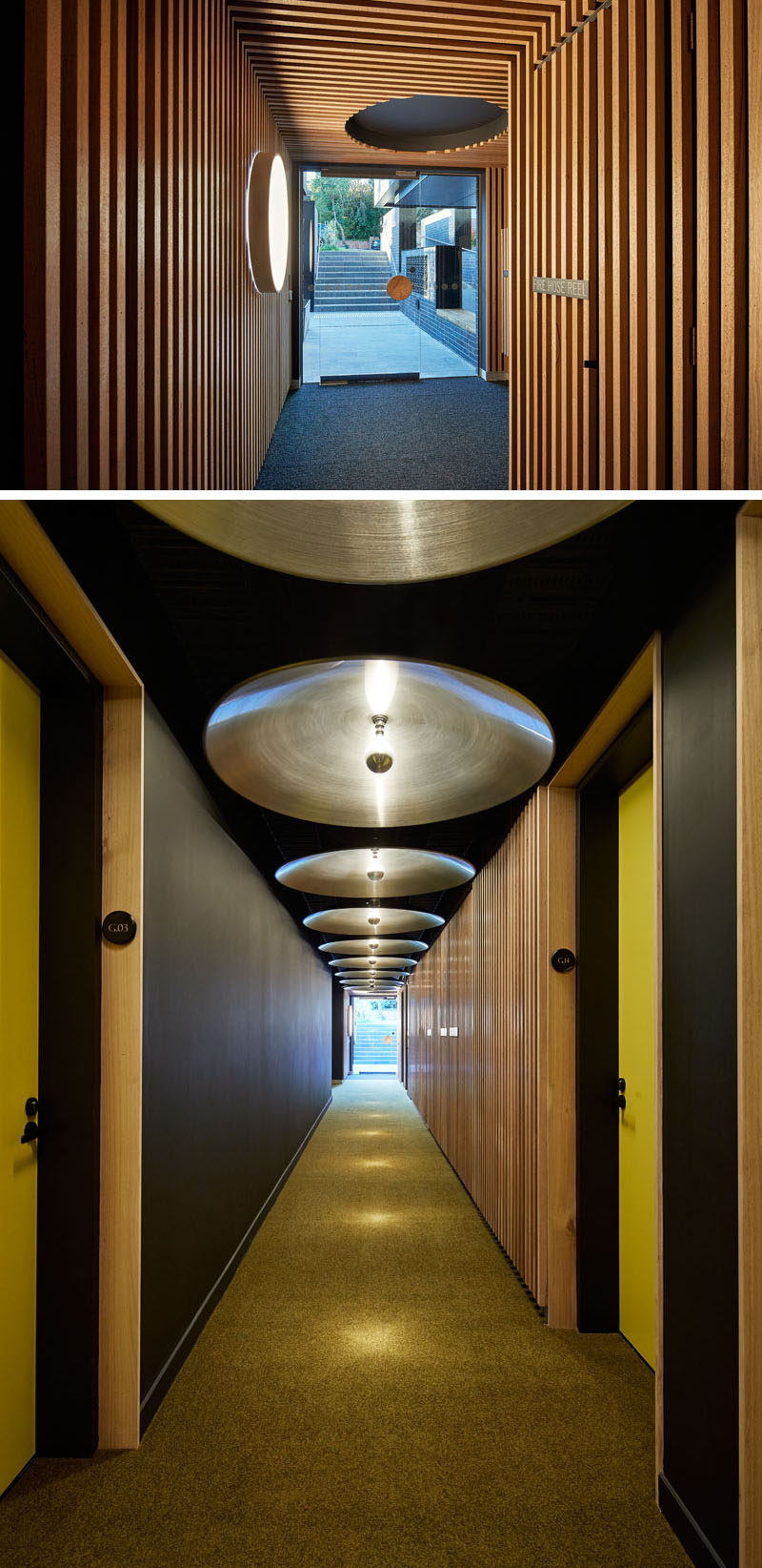 Inside this modern apartment building's entrance are wooden slats that cover the walls and ceiling, while circular elements can be found throughout the interior, like in the hallway, where the designers have used discs mounted to the ceiling to reflect the light of single bulbs. #Lobby #Hallway #WoodSlats #ModernLighting