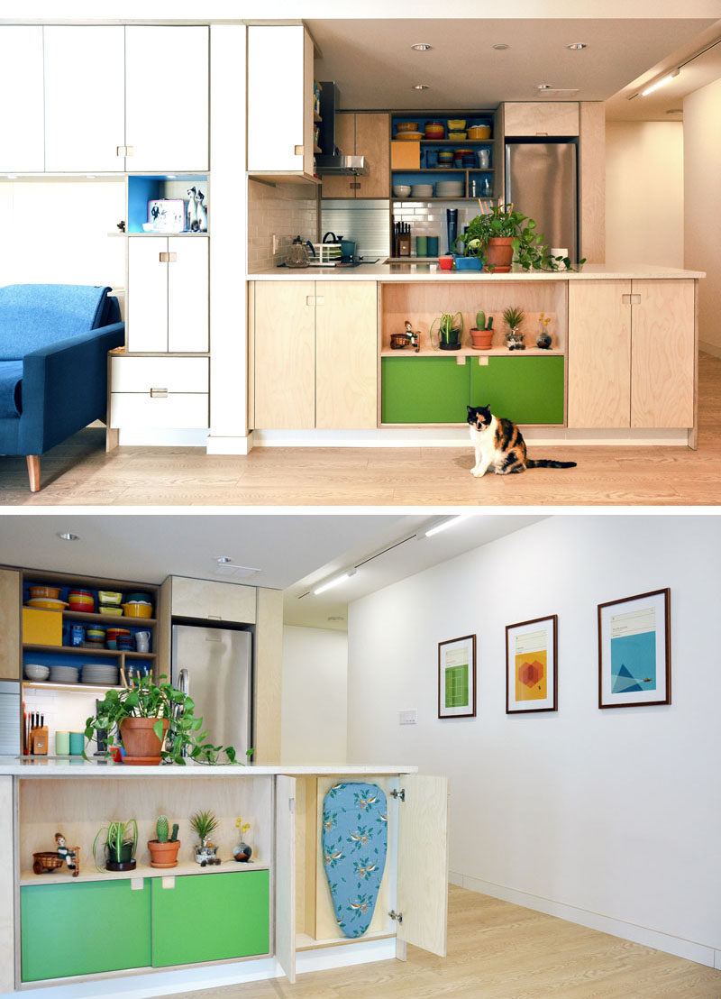 On the front of this modern kitchen, cabinets open to reveal a small ironing board that's tucked away. #Storage #InteriorDesign