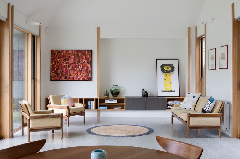 This contemporary living room has built-in wood storage that matches the wood frames found throughout the house. #LivingRoom #LivingRoomStorage #Wood