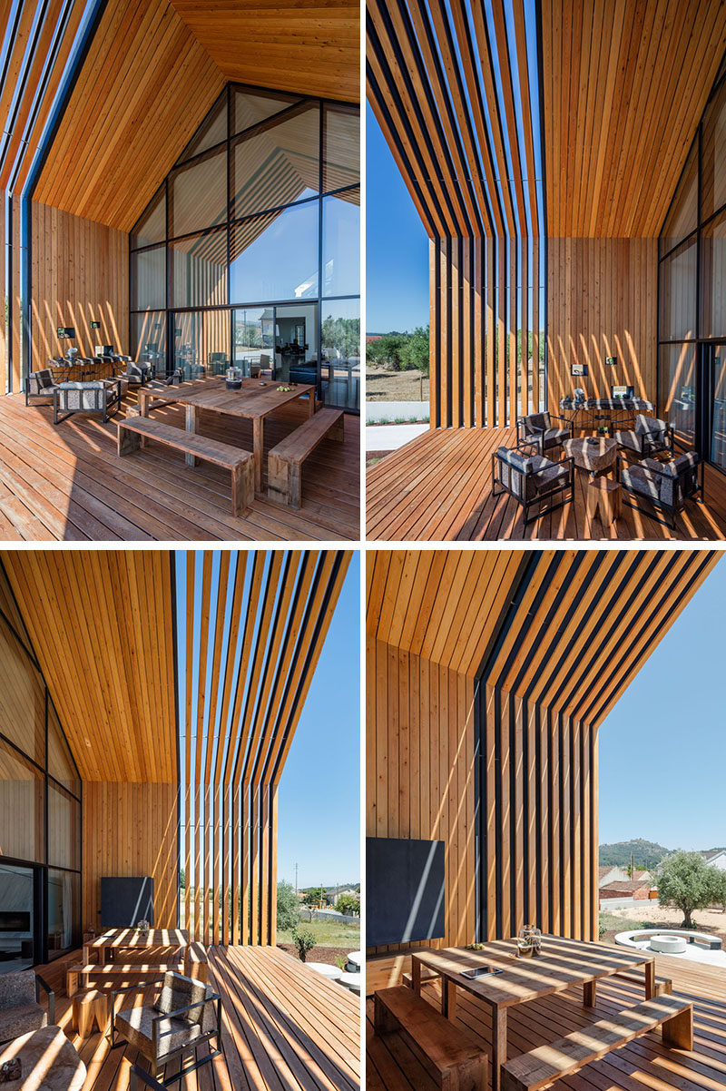 This modern house has a large wall of windows that provides access to a covered deck that's surrounded by wood. The deck has been set up as an outdoor dining and lounging area. #Deck #Architecture #ModernHouse #OutdoorDining