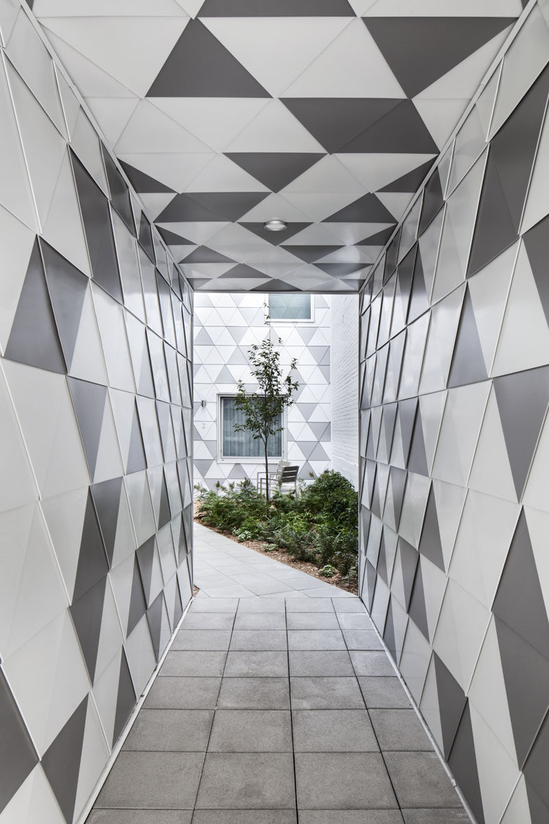 ADHOC architectes have designed a small, brick residential building in Montreal, Canada, that has geometric entryway and is inspired by a Geode. #Architecture #BuildingDesign