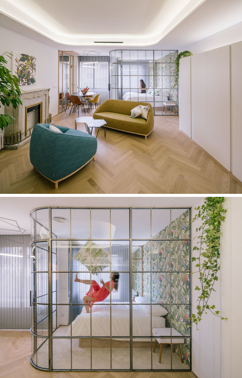 This modern bedroom is separated from the rest of the apartment by a framed glass wall. #GlassWall #BedroomDesign #FramedGlassWall #InteriorDesign #ModernBedroom