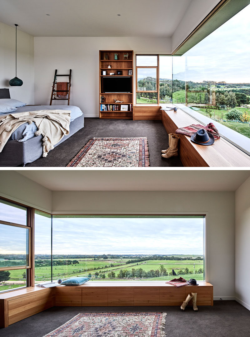 In this modern bedroom, a large window perfectly frames the view, while a wood bench has been built to create a space to sit and relax. #BedroomDesign #Window #WoodBench