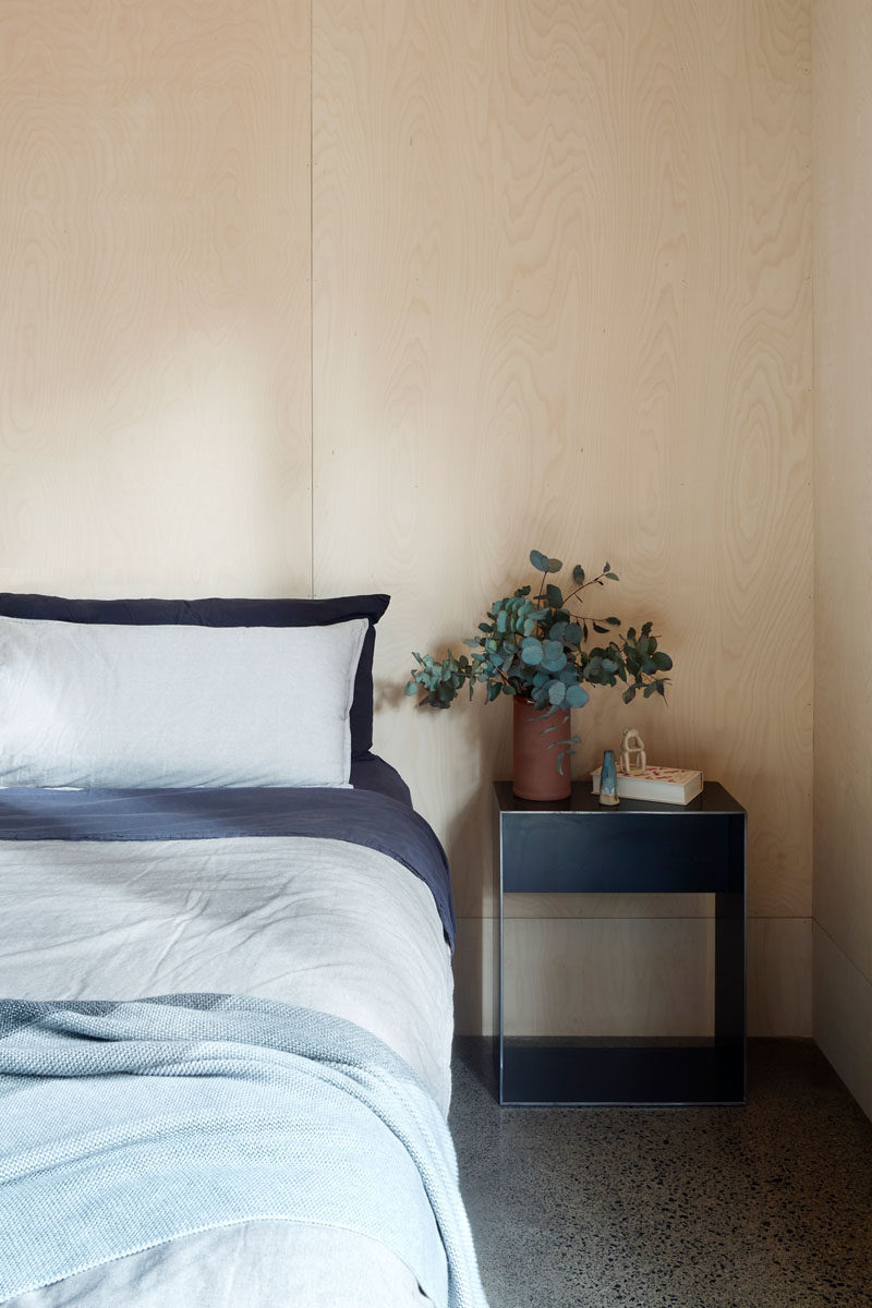 Light plywood has been used for the walls in this minimalist bedroom. #Plywood #ModernBedroom #BedroomDesign