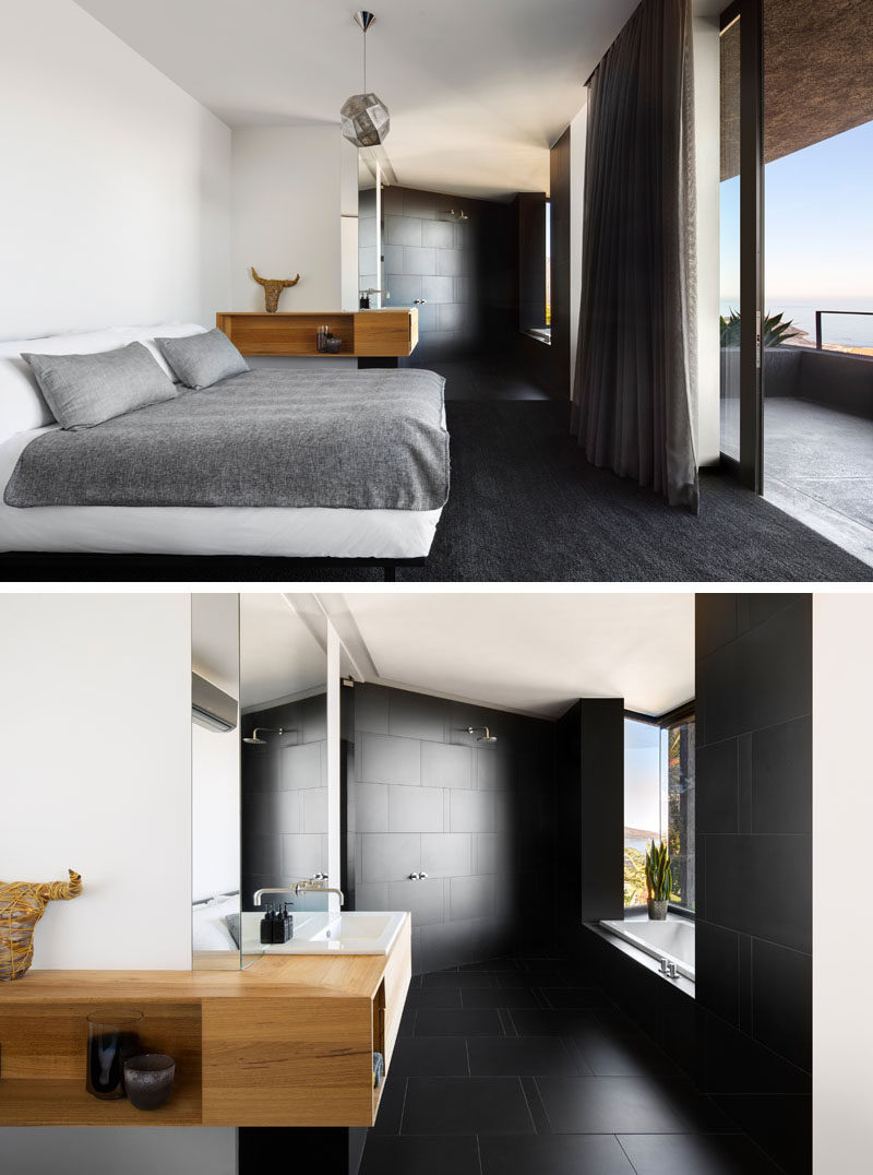 In this modern bedroom, black carpets contrast the white walls and bed, while a black en-suite bathroom with a built-in bathtub is open to the rest of the room. #BlackCarpet #ModernBedroom #EnsuiteBathroom #BlackBathroom