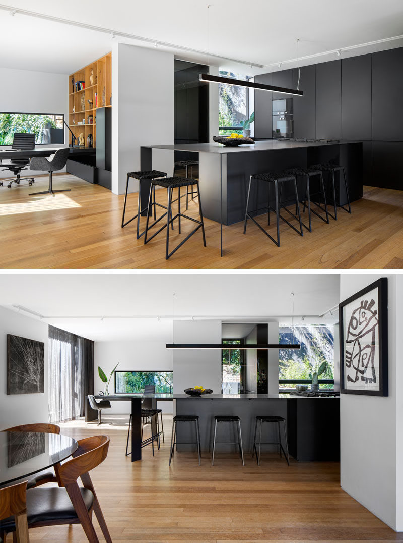 In this bold kitchen, matte black kitchen cabinets have been paired with a large black island with plenty of seating to create a modern appearance. #BlackKitchen #KitchenDesign #ModernKitchen