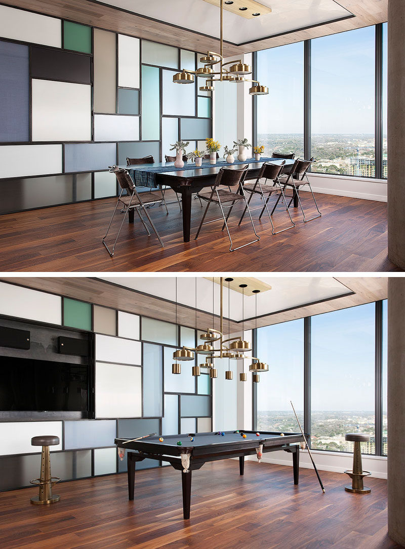 This modern apartment has a steel and glass wall that's reminiscent of a Piet Mondrian art piece. A section of the wall opens to reveal a television, while the custom-designed dining table can easily transform into a pool table. #DiningRoom #ApartmentDesign #InteriorDesign #PoolTable