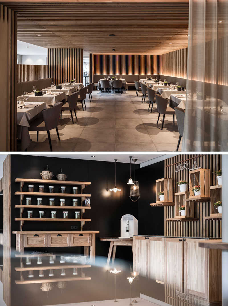 Wood slats cover the walls and ceiling in this modern hotel dining room, and hidden lighting highlights the design and creates a relaxing atmosphere. #ModernRestaurant #Wood #HotelDesign #HotelInterior