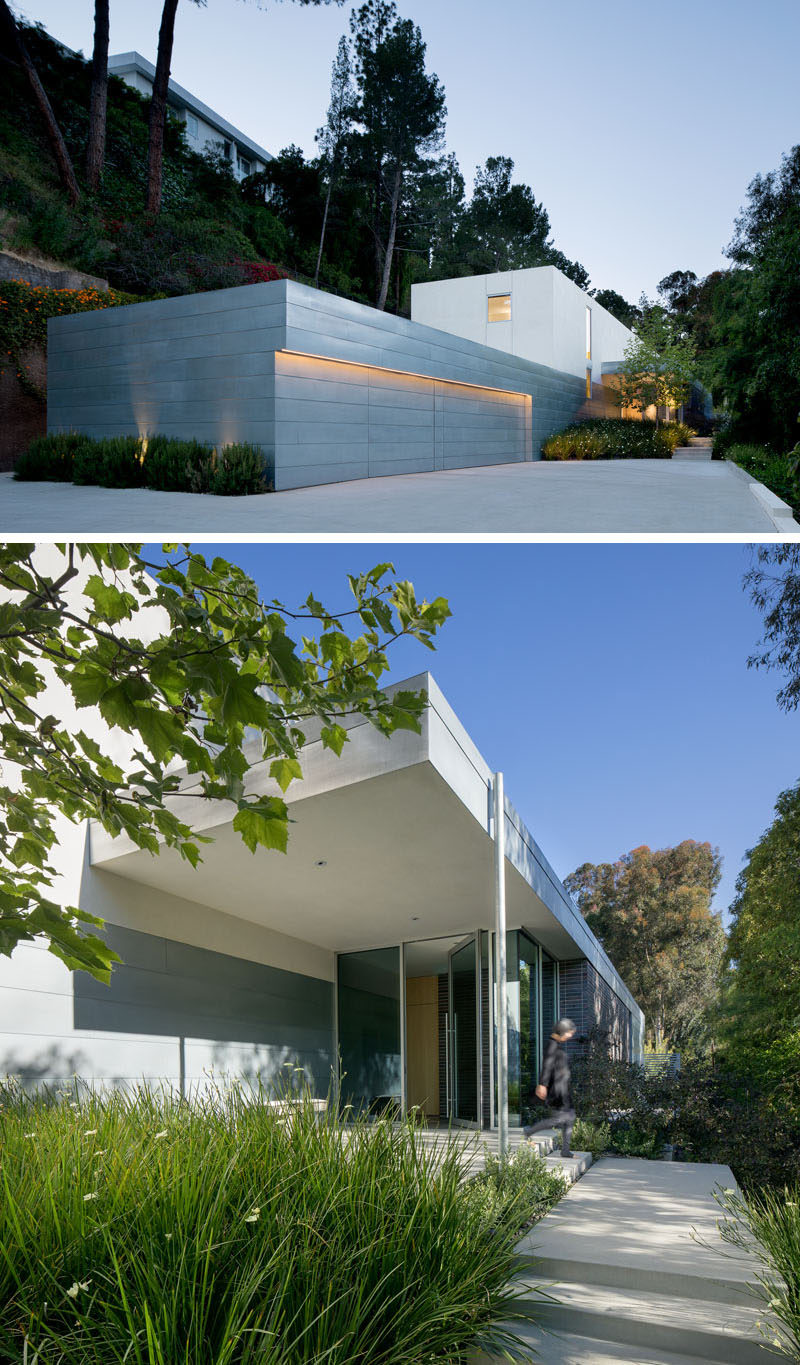 Upon arriving at this modern house, you are greeted by a large garage and a small garden with a path that leads to the glass front door. #ModernHouse #ModernGarage #Landscaping