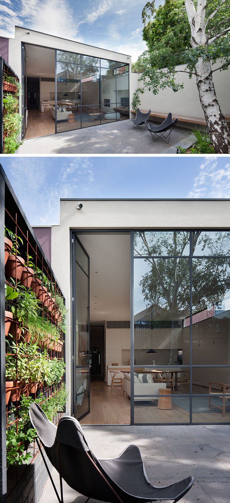 In this modern courtyard, a high wall and black fence provide privacy from the neighbors. A built-in bench and a couple of outdoor chairs create spaces to relax, and built-in planters and a wall of potted plants add a touch of nature. #Landscaping #Courtyard #PlantWall #Windows