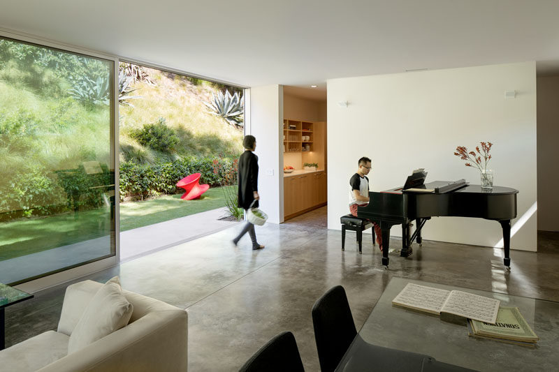 Inside this modern guest house, there's a living room / music room and the large sliding glass door allows plenty of daylight to enter the interior. #SlidingGlassDoor