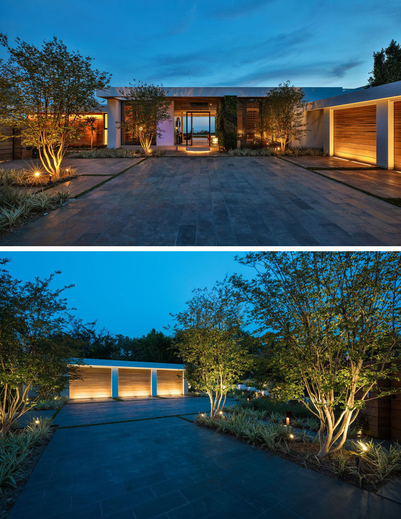 Upon arriving at this modern house, you are greeted by uplighting that highlights the landscaping and the garage. #ModernHouse #ExteriorLighting #Garage #Landscaping #Architecture