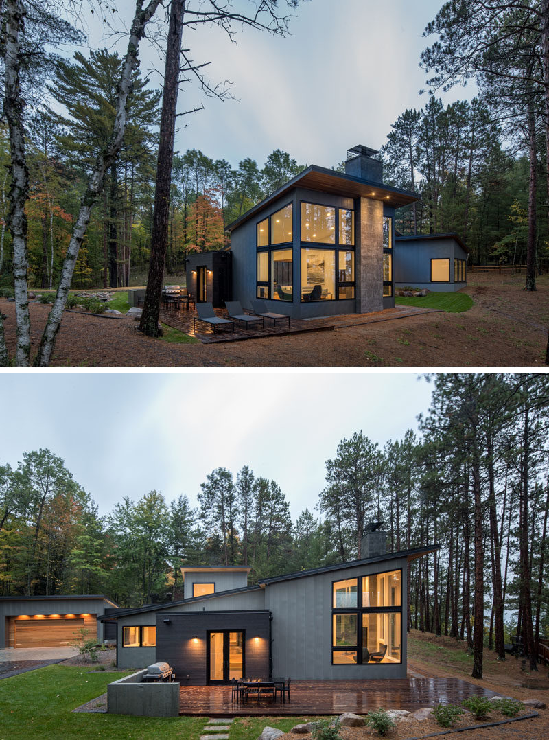 This modern house that's surrounded by trees, has an outdoor patio that's been set up with a bbq, outdoor dining and sun lounges. #Patio #ModernHouse #ModernArchitecture