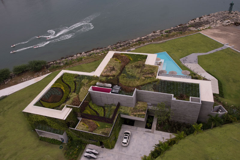 Architecture firm Ezequiel Farca + Cristina Grappin designed a waterfront home in Puerto Vallarta, Mexico, that features a large green roof and expansive outdoor entertaining spaces. #ModernHouse #GreenRoof #HouseDesign #WaterfrontHouse